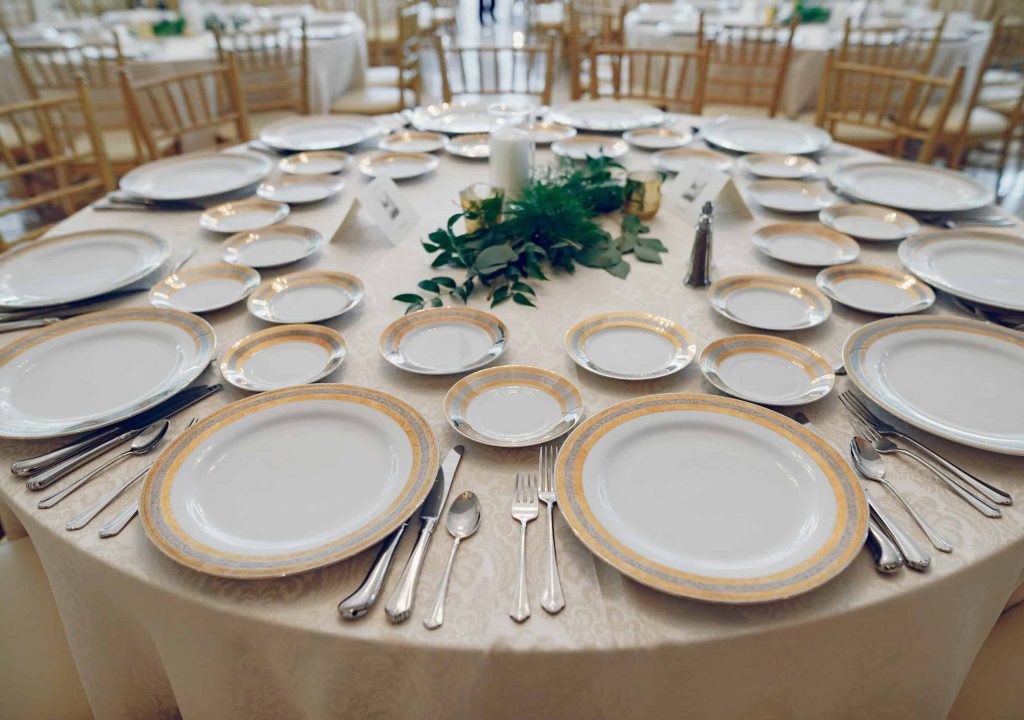 Beautiful wedding decor. Golden dishes in a wedding table